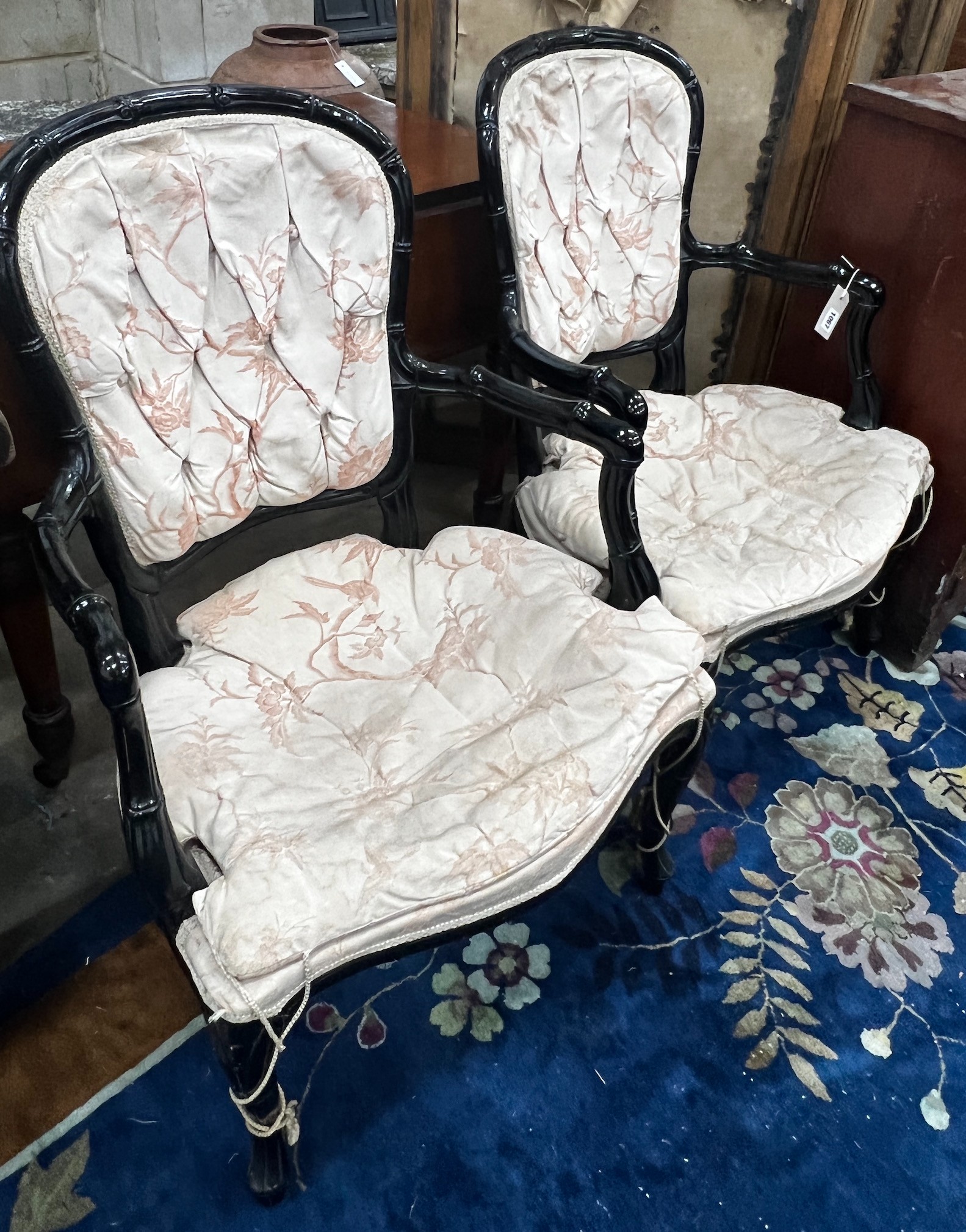 A pair of ebonised faux bamboo elbow chairs, width 58cm depth 50cm height 90cm